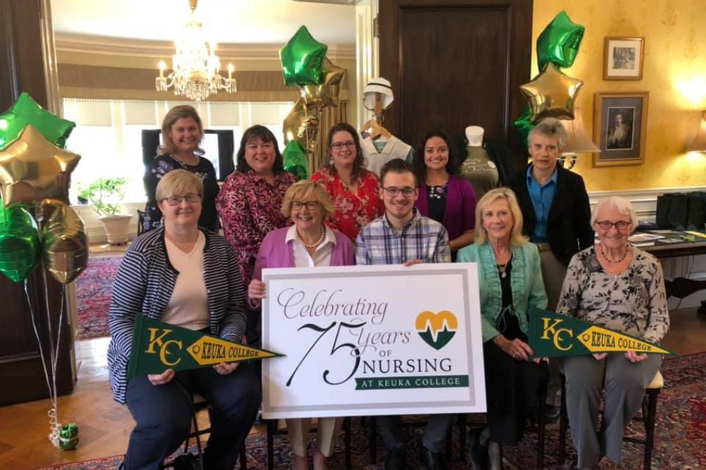 A group of alumni and faculty at a 75th anniversary of nursing celebration