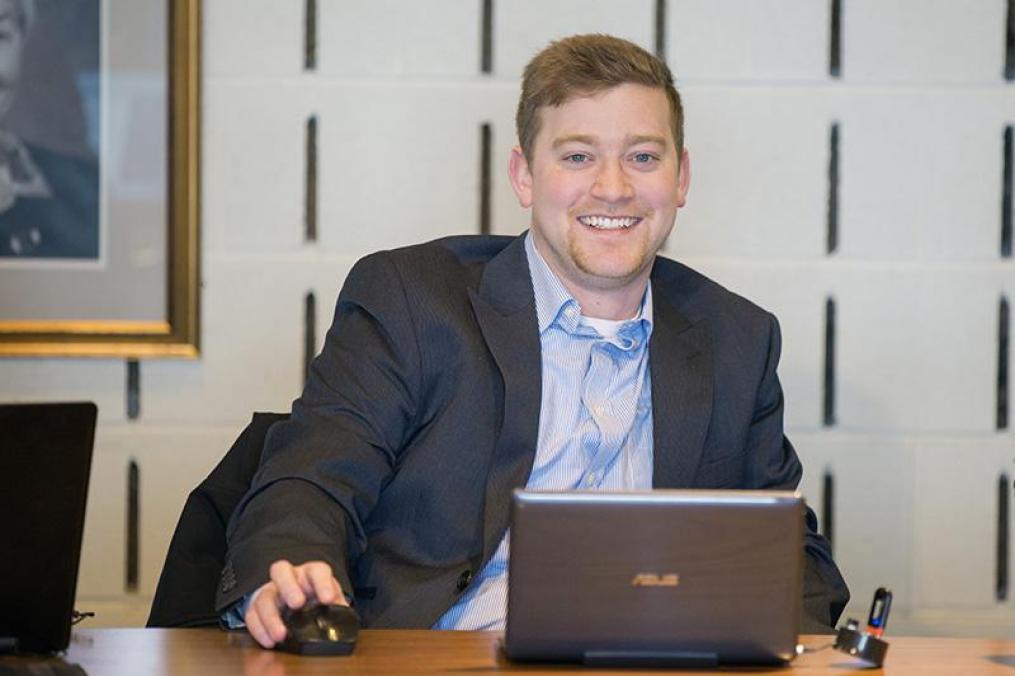 A business student sits at his laptop.