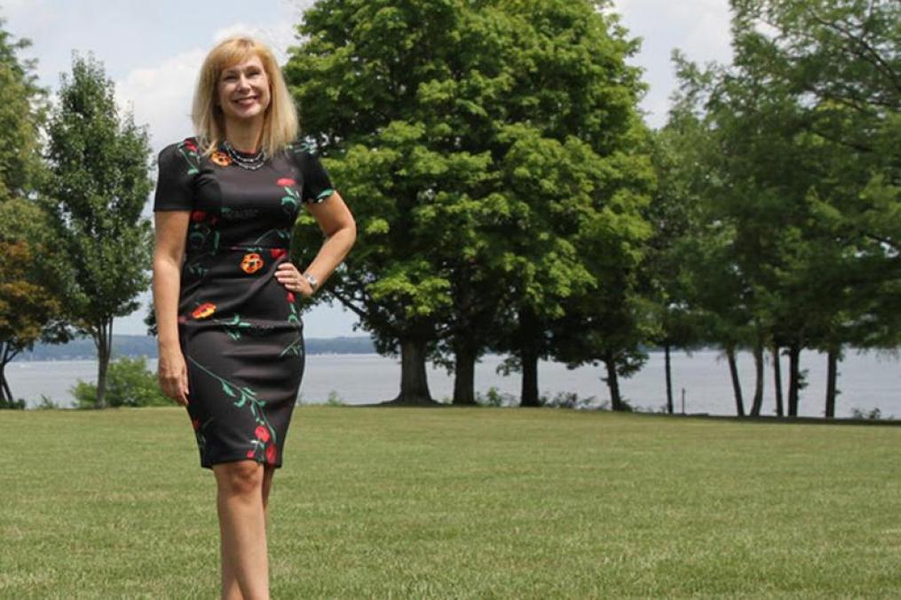 Portrait of Amy Storey standing in front of Keuka Lake