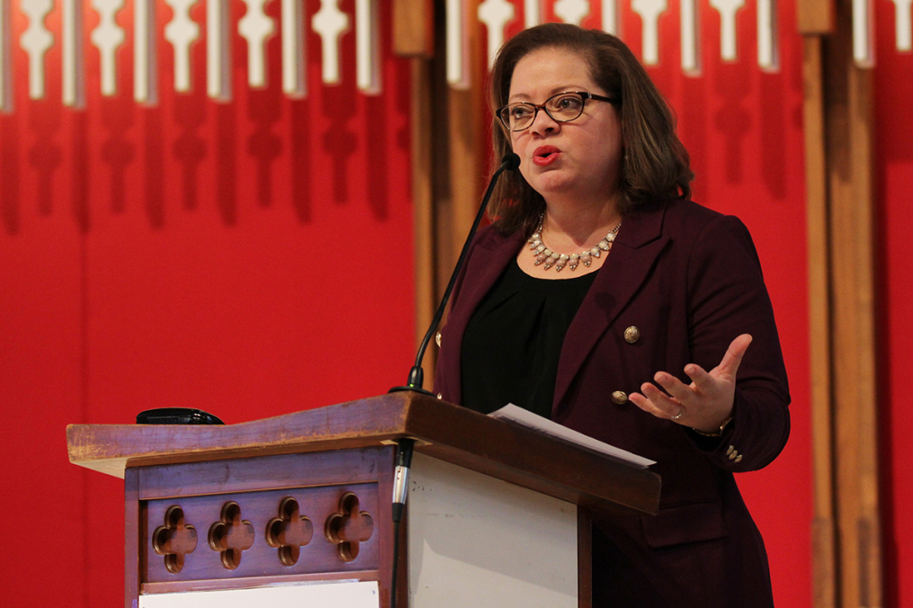 Norma Holland standing at a podium