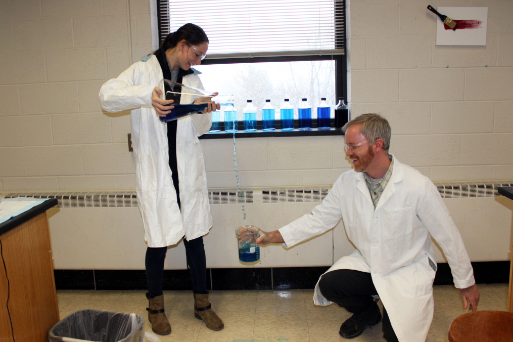 Danielle DeSimone pouring liquid into a beaker