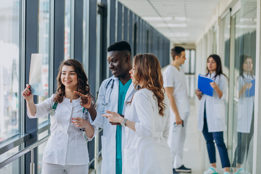 a group of young doctors in healthcare looking at an xray