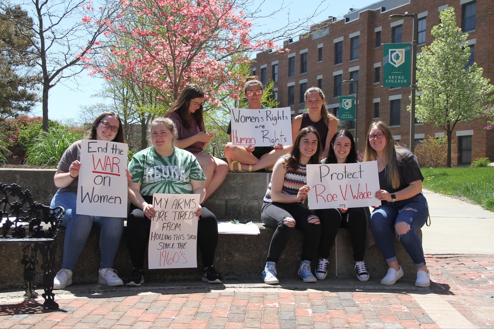 Students holding signs in peaceful demonstration of their opposition to the overturn of Roe v. Wade