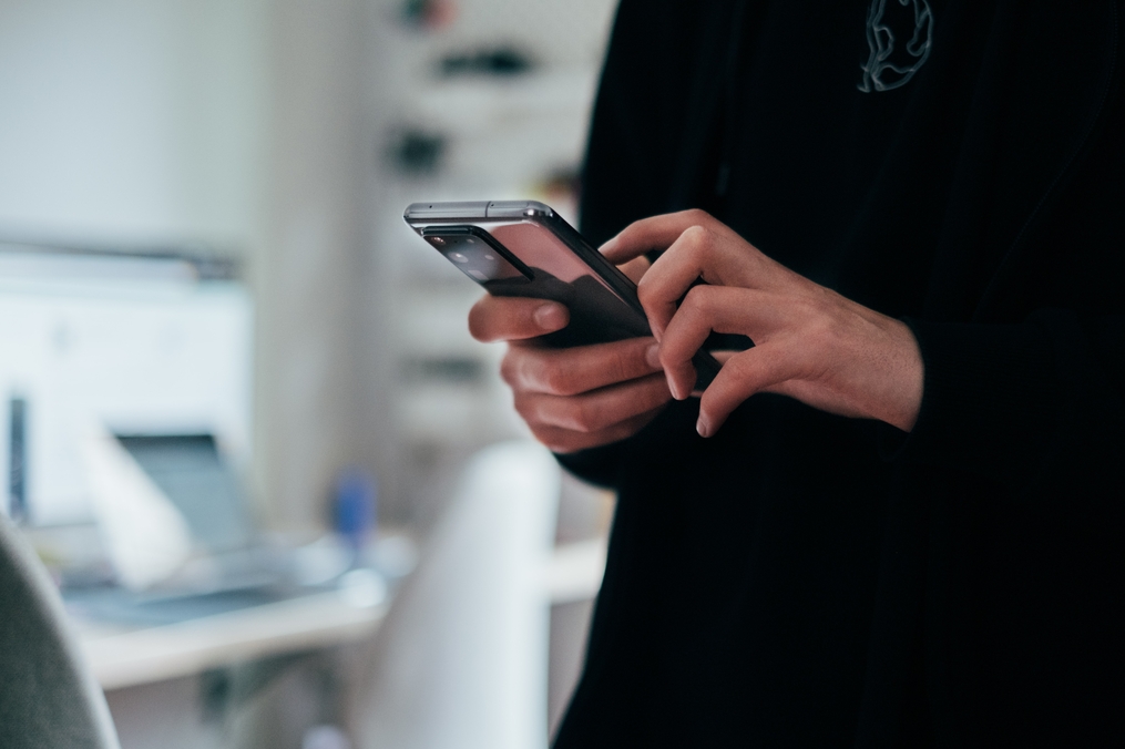 Person typing on smartphone 