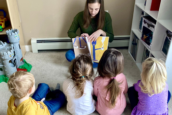Mary Hennesy reading to children