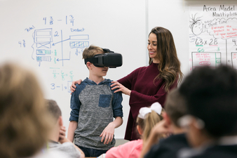Student working with teacher using Virtual Reality technology